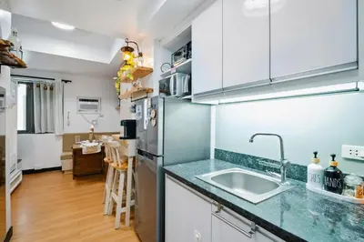 a kitchen with a sink and a refrigerator at Coastal Studio in KL Tower Serviced Residences, Greenbelt, Makati! Maximum capacity 5 pax! in Manila