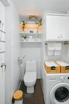 a bathroom with a toilet and a washing machine at Coastal Studio in KL Tower Serviced Residences, Greenbelt, Makati! Maximum capacity 5 pax! in Manila