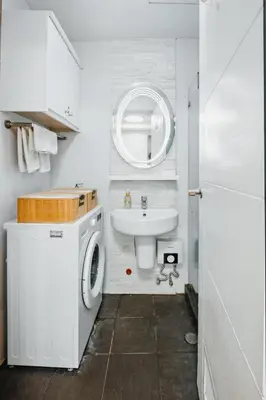 a bathroom with a washing machine and a sink at Coastal Studio in KL Tower Serviced Residences, Greenbelt, Makati! Maximum capacity 5 pax! in Manila