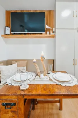 a table with plates and glasses on top of it at Coastal Studio in KL Tower Serviced Residences, Greenbelt, Makati! Maximum capacity 5 pax! in Manila