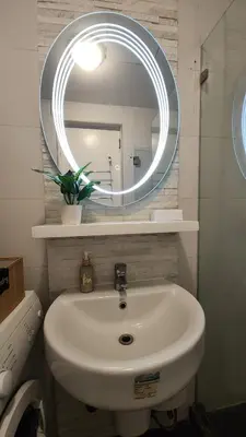 a bathroom with a white sink and a mirror at Coastal Studio in KL Tower Serviced Residences, Greenbelt, Makati! Maximum capacity 5 pax! in Manila