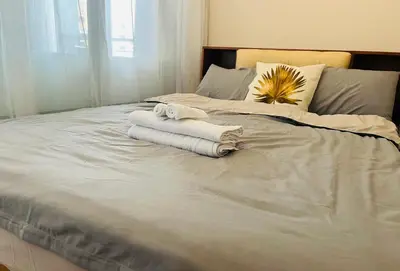 a bed with two towels on top of it at Astra Heights Staycation in Manila