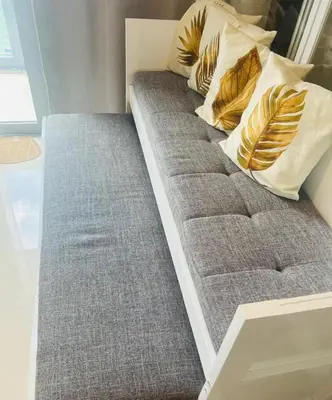 a bed with pillows on it in a room at Astra Heights Staycation in Manila