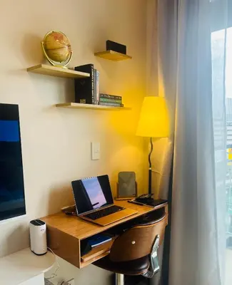 a desk with a laptop computer on top of it at Astra Heights Staycation in Manila