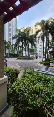 a view of a street with palm trees and buildings at Rqui Condotel Pasay City Manila in Manila