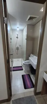 a bathroom with a sink and a toilet and a shower at Rqui Condotel Pasay City Manila in Manila