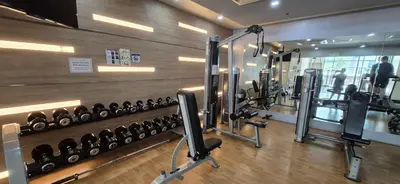 a gym with a row of dumbbells on the wall at Rqui Condotel Pasay City Manila in Manila