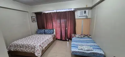 a small room with two beds and a window at Rooms in Pasay Manila Nearest To Airport Terminal 3 in Manila