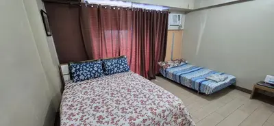 a small bedroom with a bed and a couch at Rooms in Pasay Manila Nearest To Airport Terminal 3 in Manila