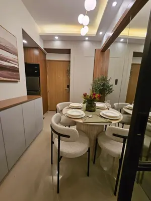 a kitchen and dining room with a table and chairs at Luxury apartment at Bloom Residences in Manila