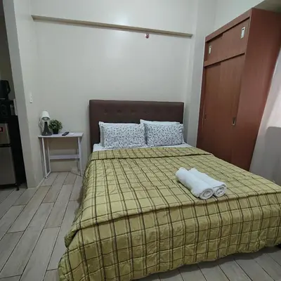 a bedroom with a bed with two towels on it at Rose 150newport pasay in Manila