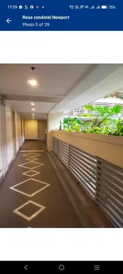 a hallway of a building with plants on the wall at Rose 150newport pasay in Manila