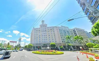 a large building on a city street with a large at Rose 150newport pasay in Manila