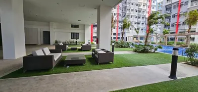 a courtyard with couches and a pool in a building at In My Jib Sucat in Manila