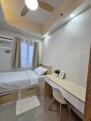 a small room with a bed and a desk at In My Jib Sucat in Manila
