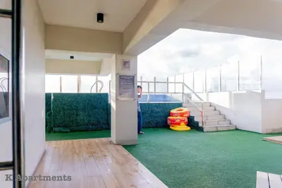 a person standing on an upper deck of a cruise ship at Spacious Condo with 50in TV & Netflix, Near Malls in Manila