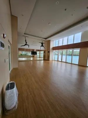 a large empty room with people jumping in the air at Luxury apartment at Park McKinley West suite 1 in Manila
