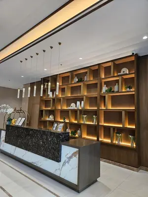 a lobby with a large wall of wooden shelves at Luxury apartment at Park McKinley West suite 1 in Manila