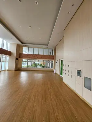 an empty room with wood floors and large windows at Luxury apartment at Park McKinley West suite 1 in Manila