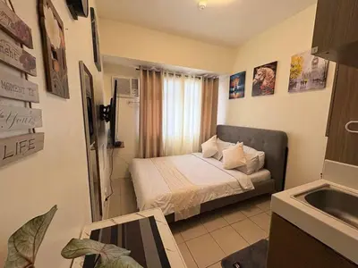 a small bedroom with a bed and a sink at JJMC HOMESTAY 28 With Netflix and Unli Wifi in Manila