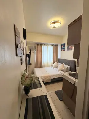 a small room with a bed and a sink at JJMC HOMESTAY 28 With Netflix and Unli Wifi in Manila