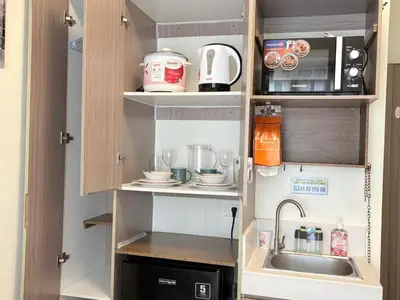 a small kitchen with a sink and a microwave at JJMC HOMESTAY 28 With Netflix and Unli Wifi in Manila
