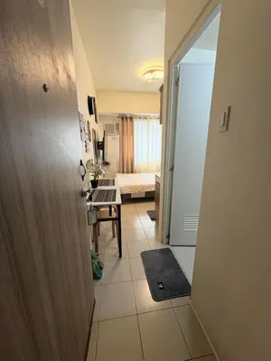 a hallway with a door leading to a room at JJMC HOMESTAY 28 With Netflix and Unli Wifi in Manila