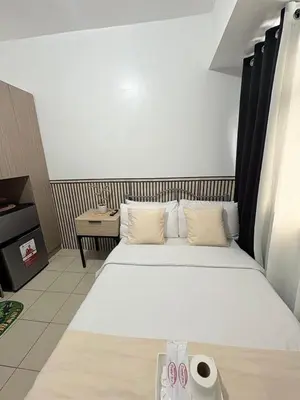 a hotel room with a large bed with two pillows at JJMC PLACE 6 With Netflix and Unli Wifi in Manila