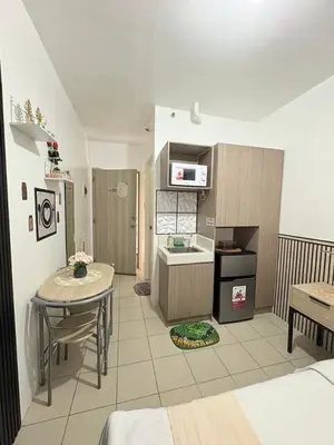 a living room with a table and a kitchen at JJMC PLACE 6 With Netflix and Unli Wifi in Manila