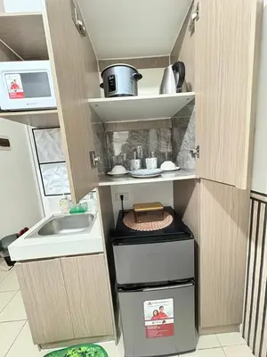 a small kitchen with a sink and a stove at JJMC PLACE 6 With Netflix and Unli Wifi in Manila