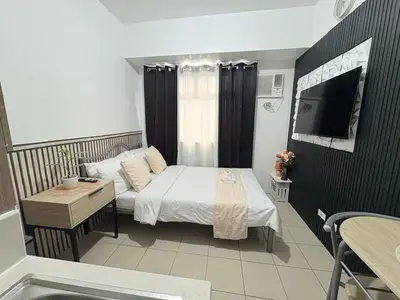 a small bedroom with a bed and a television at JJMC PLACE 6 With Netflix and Unli Wifi in Manila