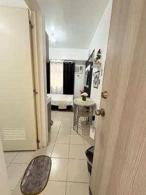 a hallway with a room with a table and a bedroom at JJMC PLACE 6 With Netflix and Unli Wifi in Manila