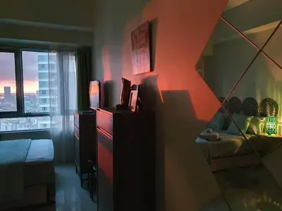 a room with a bedroom with a bed and a window at Zeke Suite At Beacon Tower Amorsolo unit 2330 in Manila