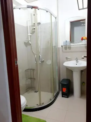 a bathroom with a shower and a sink at Zeke Suite At Beacon Tower Amorsolo unit 2330 in Manila