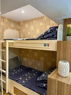 two bunk beds in a small room with at Staycation at Starmall in Manila