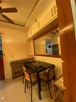 a kitchen with a table and chairs in a room at MJ&J Breeze Staycation in Manila