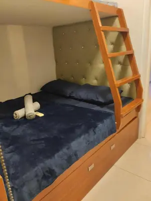 a bunk bed with a teddy bear and a ladder at MJ&J Breeze Staycation in Manila