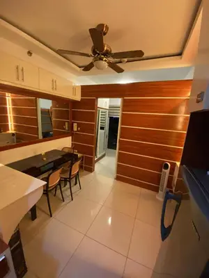 a kitchen with a ceiling fan and a table at MJ&J Breeze Staycation in Manila