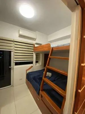 a bedroom with bunk beds in a small room at MJ&J Breeze Staycation in Manila