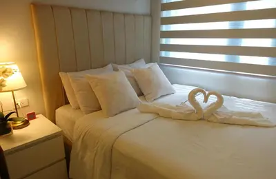a bed with two heart shaped towels on it at F&M Deluxe Holiday Suite MOA SHORE 3 Residences