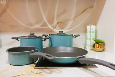 two pots and pans sitting on top of a stove at F&M Deluxe Holiday Suite MOA SHORE 3 Residences
