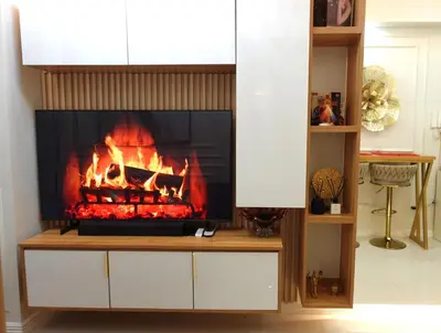 a fireplace in a living room with a fire at F&M Deluxe Holiday Suite MOA SHORE 3 Residences