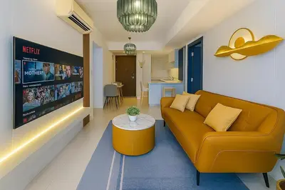 a living room with a couch and a table at Luxury & Modern 2BR Penthouse in BGC in Manila
