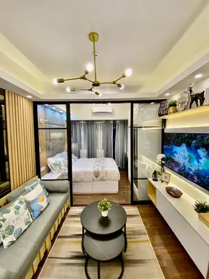a living room with a couch and a fish tank at Edin's Home in Manila