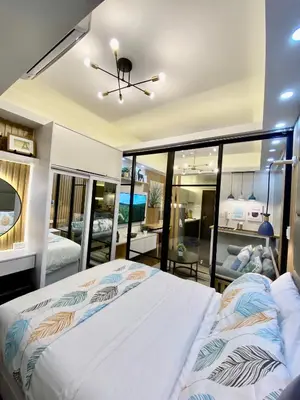 a bedroom with a large white bed in a room at Edin's Home in Manila