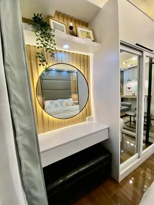 a bedroom with a mirror on a wall at Edin's Home in Manila