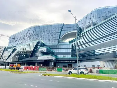 a large building with a car parked in front of it at Modern 1BR Stay near Solaire, Okada, near Airport in Manila