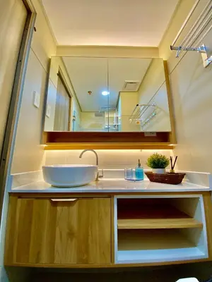 a bathroom with a sink and a mirror at Calix Suite in Manila