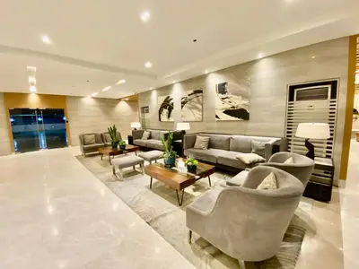 a large living room with couches and a table at Calix Suite in Manila