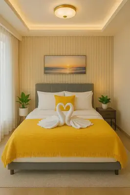 a bedroom with a yellow bed with two white towels at Luxury Suites near Okada, Solaire, City of Dreams in Manila